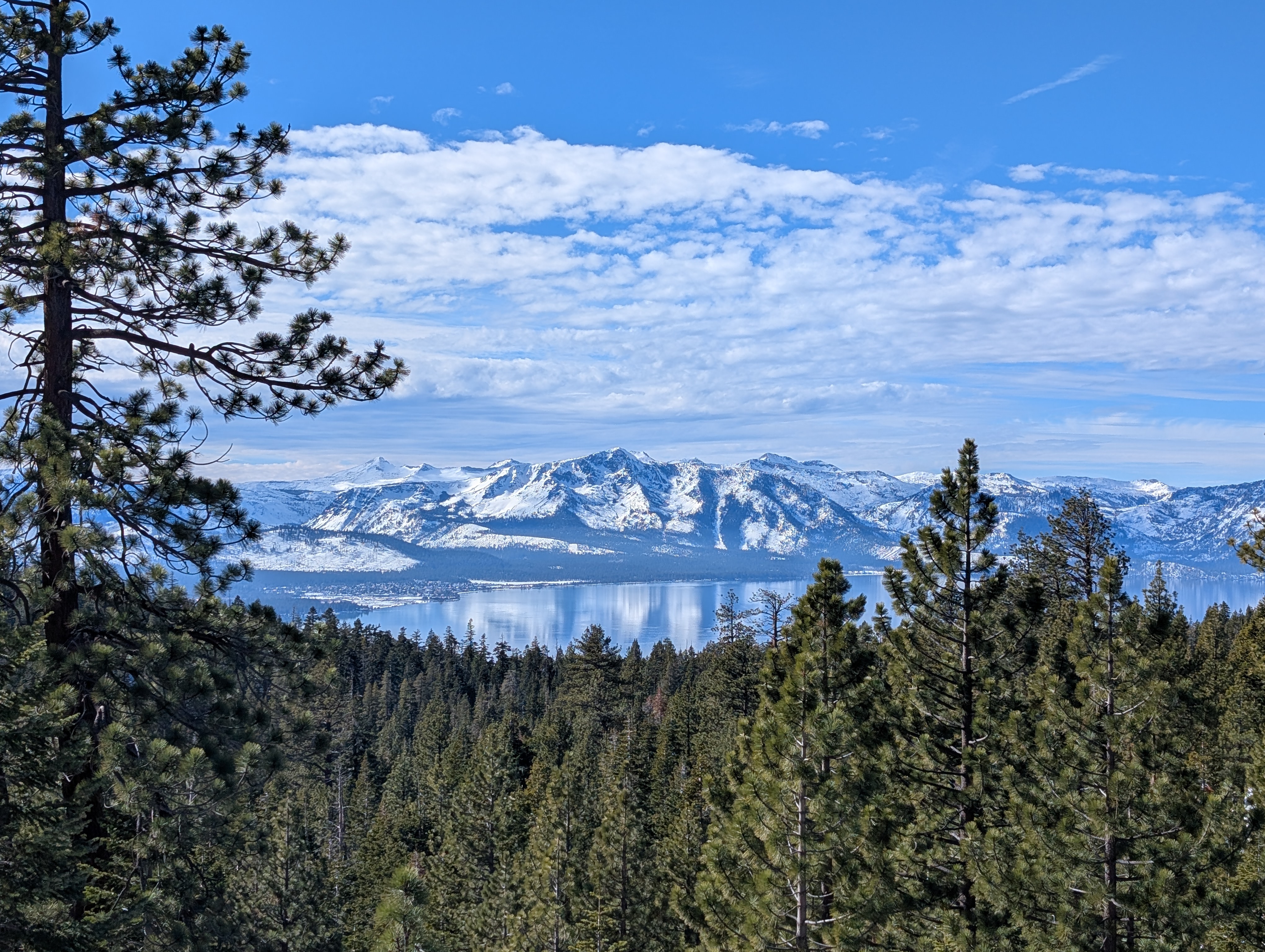 A view of Tahoe and snow-covered mountains behind it